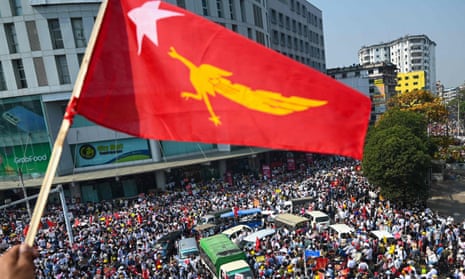 A protester waves the National League for Democracy flag in Yangon