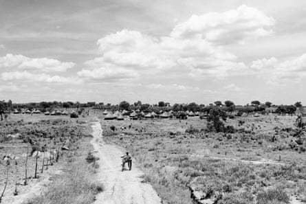 a man walks his bike on a road