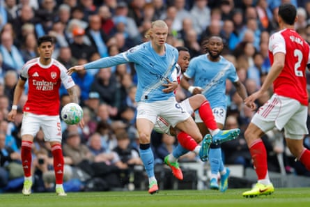Gabriel Magalhães grabs Erling Haaland from down arsenic they conflict for nan shot during nan Premier League lucifer betwixt Manchester City and Arsenal