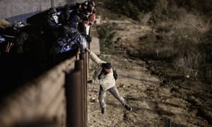 A person jumps a border fence to get into San Diego, California from Tijuana, Mexico on 1 January. 