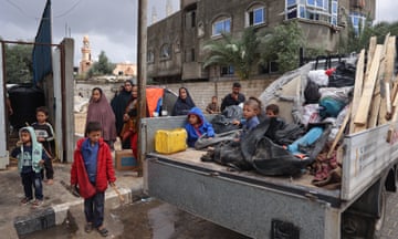Displaced Palestinian people prepare to move