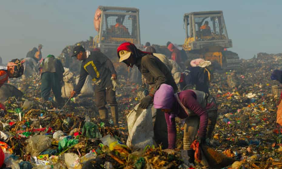 People scavenge at a rubbish tip in Medan. Some 93 million Indonesians are living below the World Bank’s ‘moderate’ poverty line of $3.10 a day.