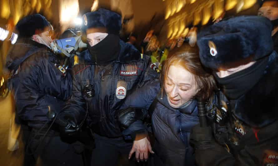 Police officers detain a supporter of opposition leader Alexei Navalny during a protest in St Petersburg, February 2021.