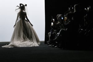 A silhouette of a model in a long dress