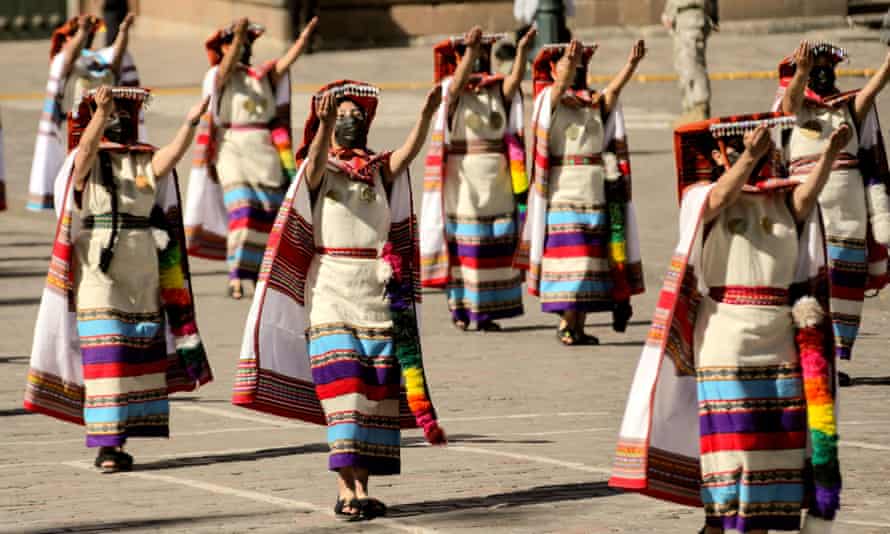 Actresses wearing face masks perform a recreation of an ancient ritual during the Inti Raymi Festival in Cuzco, Peru.