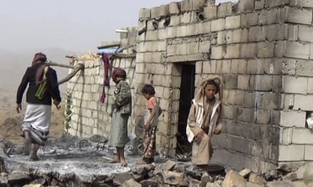 Residents inspect a house that was damaged during a 29 January US raid on the tiny village of Yakla, in central Yemen.