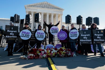 Eight activists stand in front of the supreme court with signs that say ‘Pray to end abortion’.