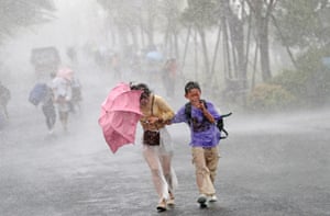 Tourists trying to walk in heavy rain