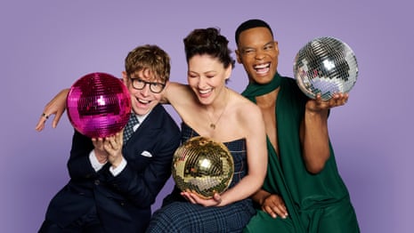 One man of colour, a man wearing glasses, and a woman in a ballgown, each holding a glitterball