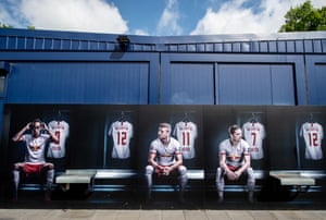 A mural shows Leipzig players Yussuf Poulsen, Timo Werner adn Marcel Sabitzer on a wall of the club shop in Leipzig.