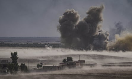 Smoke plumes rise after a series of airstrikes in Mosul.