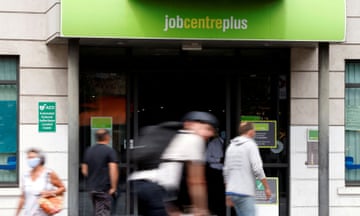 People walk past a branch of Jobcentre Plus