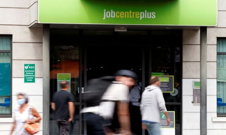 People walk past a branch of Jobcentre Plus