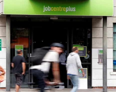 People walk past a branch of Jobcentre Plus