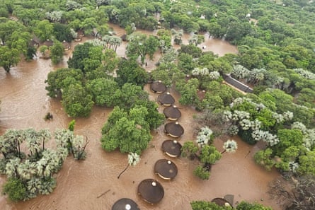 Aerial view of flooded huts among the trees