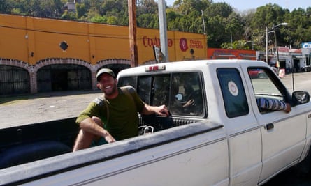 Rob Greenfield on one of several free rides in Mexico. He is sitting in the back of a pickup truck.