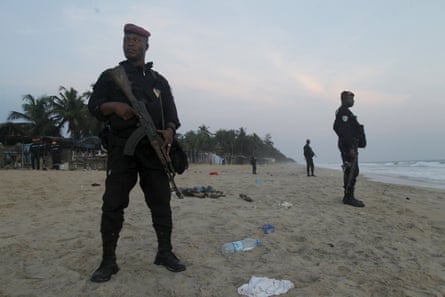 Soldiers stand in guard on the beach in Grand Bassam