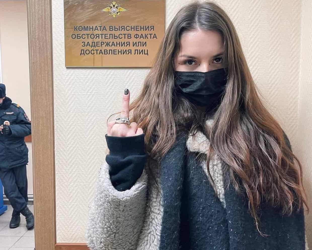 Rita Flores in a mask giving the middle finger to the camera
