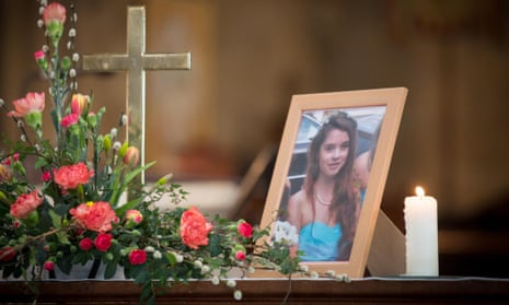 A candle burns besides a photograph of Becky Watts at St Ambrose Church 