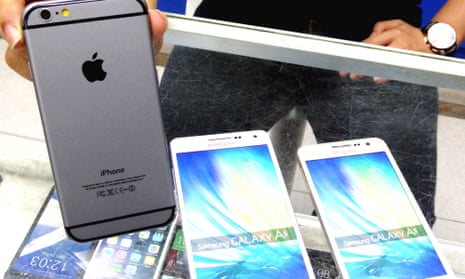 A shop clerk displays an iPhone 6. Some 41,000 fake iPhones had been made in the factory raided by police.
