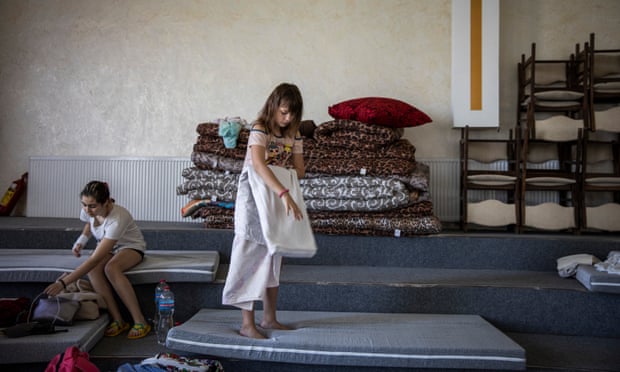 Victoria Soldatova (centre) packs up her bed at an IDP shelter at Light of the Gospel Church in Dnipro, Ukraine.