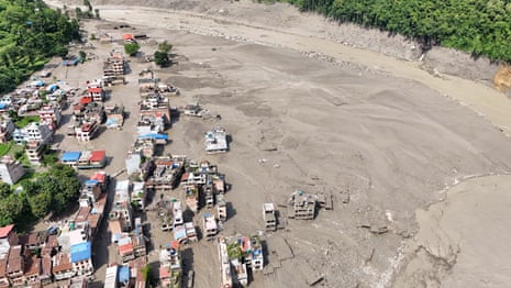 An aerial view shows buildings and infrastructure damaged along the swollen Trishuli River following a massive flash flood triggered by an avalanche of ice and rock in the upper Lhende River on the Tibetan side.