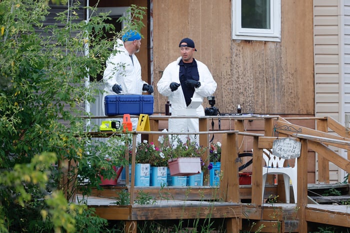 Two members of a forensic team examine evidence.