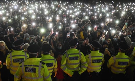 People shine phone torches during a vigil for Sarah Everard on Clapham Common in March 2021.