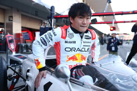 Yuki Tsunoda climbing into his Red Bull car at Suzuka