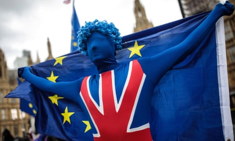A protester outside parliament dressed in a Union flag and holding an EU flag