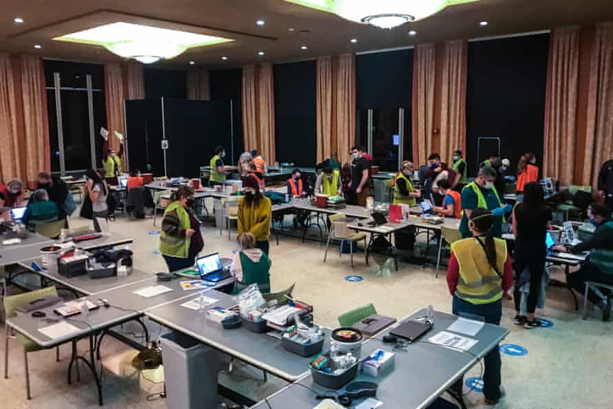 Healthcare workers rush to distribute Covid vaccines after a freezer crash in the middle of the night in Seattle.