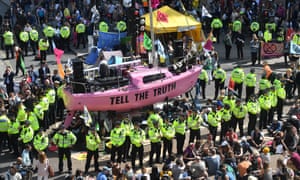 Police surround a pink boat in London