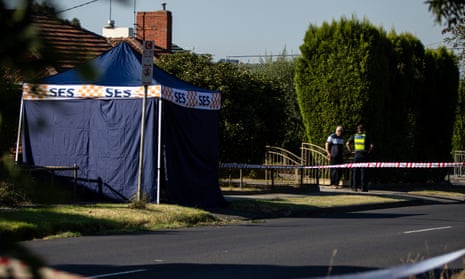 A member of Victoria police speaks with a resident after a man fell to his death from a hot air balloon in the Melbourne suburb of Preston