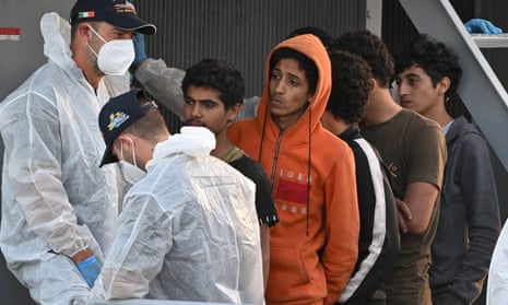 People rescued from a boat in the Mediterranean arriving at Messina, Sicily in October.