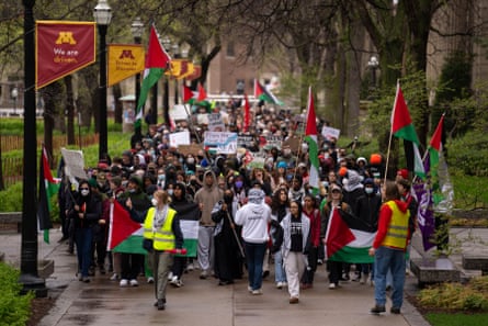a group of people carrying Palestinian flags at a protest