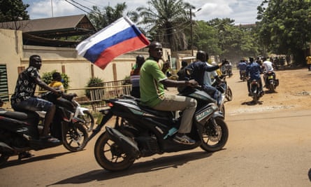 Supporters of Capt. Ibrahim Traore wave a Russian flag in the streets of Ouagadougou, Burkina Faso, October 2022.