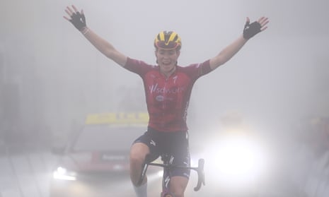 Demi Vollering celebrates as she crosses the line to win on the Col du Tourmalet.