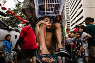 A boy carries a girl on his shoulders