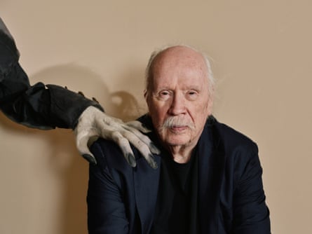 John Carpenter with a monster hand on his shoulder