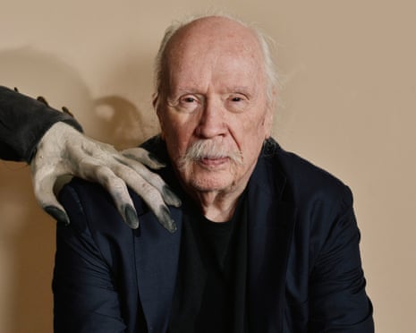 Carpenter in a black suit with a creepy hand on his shoulder