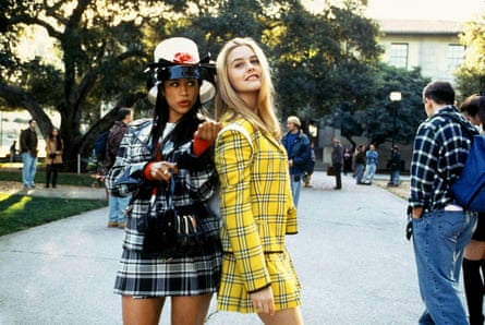 two teenage girls in plaid sets outside of a school