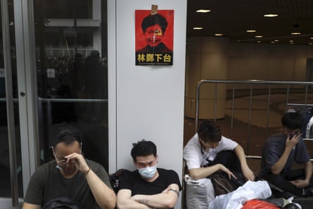 Protesters below a photo of Hong Kong’s chief executive Carrie Lam with the words “Step down”.
