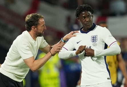 Gareth Southgate speaks to Kobbie Mainoo before he came on against Slovenia