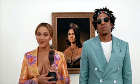 Beyoncé and Jay-Z accept the 2019 Brit award for best international group in front of a portrait of Meghan Markle.