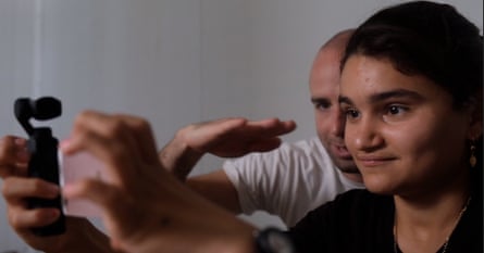 Mediha is taught how to use the video camera by the documentary’s director Hasan Oswald.