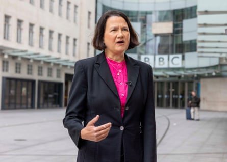 Catherine West speaks in the courtyard outside the BBC building in London. She is 59 and has short dark hair in a chin-length bob. She wears a black jacket over a bright pink blouse.