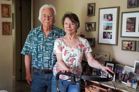a husband and wife stand for a portrait