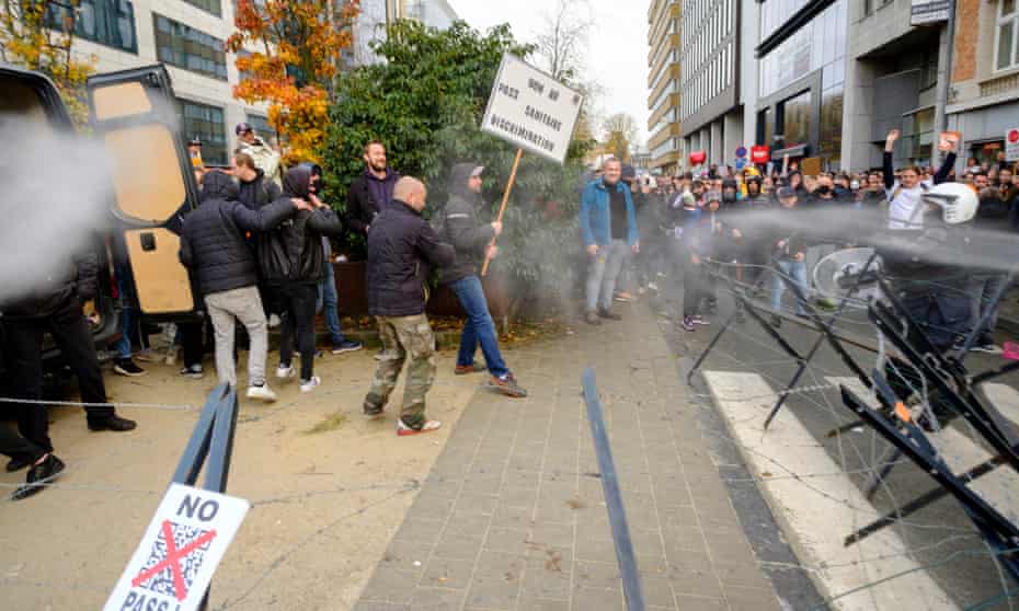 Police spray protesters as they gather in front of the Gare du Nord in Brussels, Belgium, for an anti-Covid pass protest.