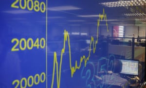 A TV screen showing a financial index rising