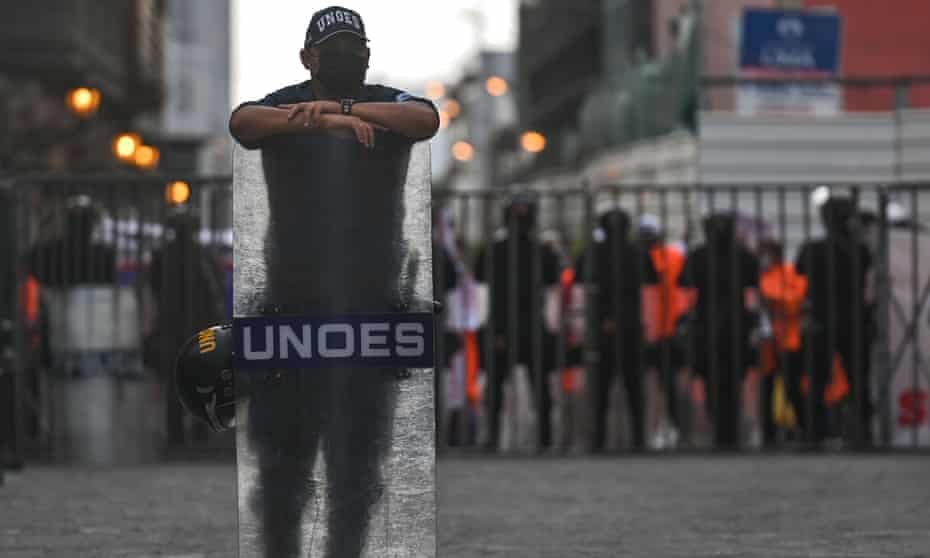 Members of the riot police block access to the main square in Lima city centre as members of the Lima Municipal Workers' Union protest a few hundred meters away on Monday.